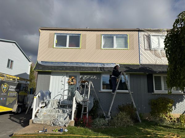 Professional spray painted home exterior in Alberta