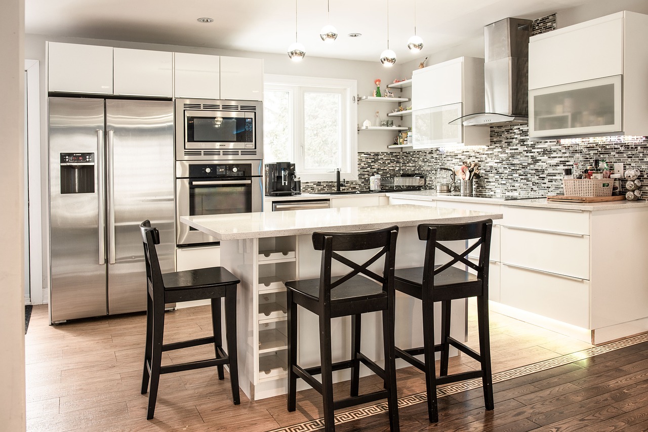 Modern white kitchen with professionally refinished cabinets