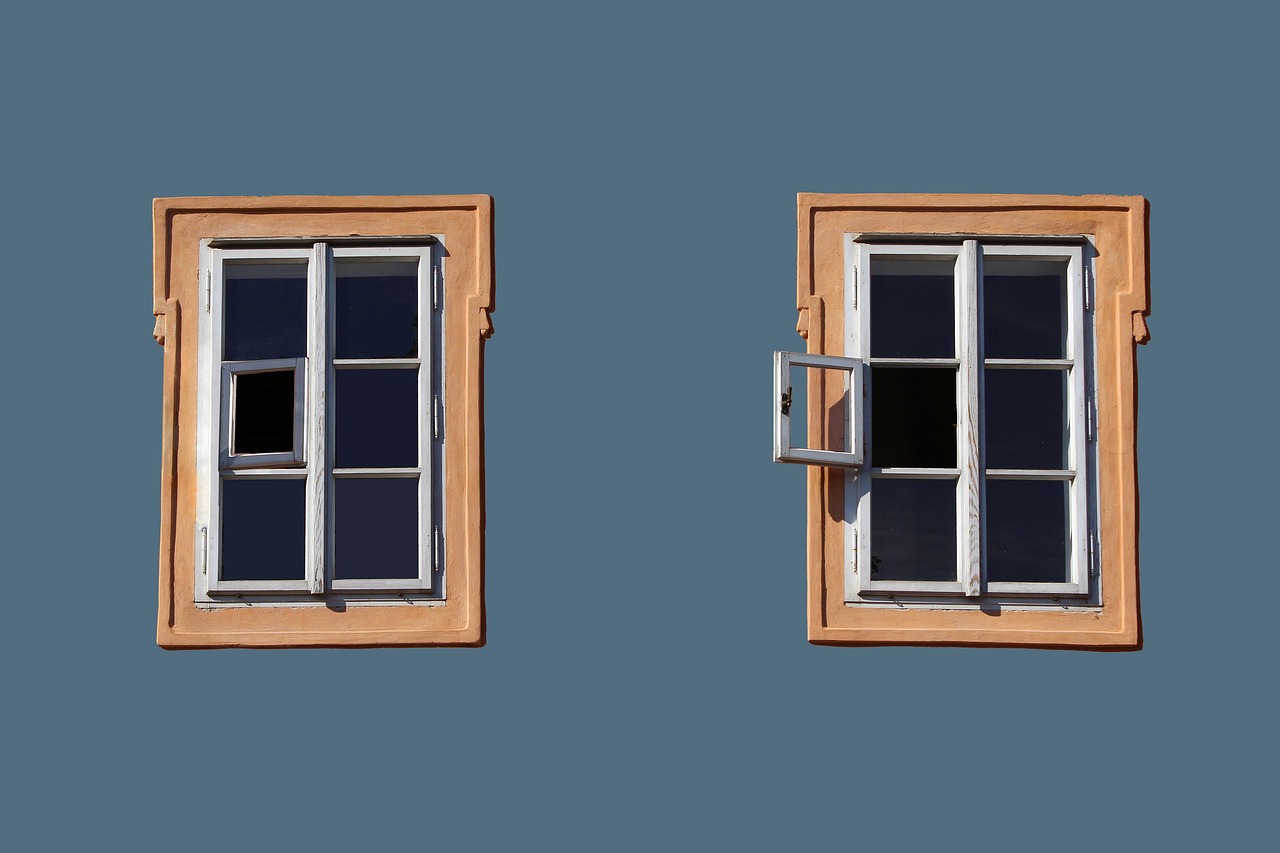 Windows with clean painted trim on exterior wall